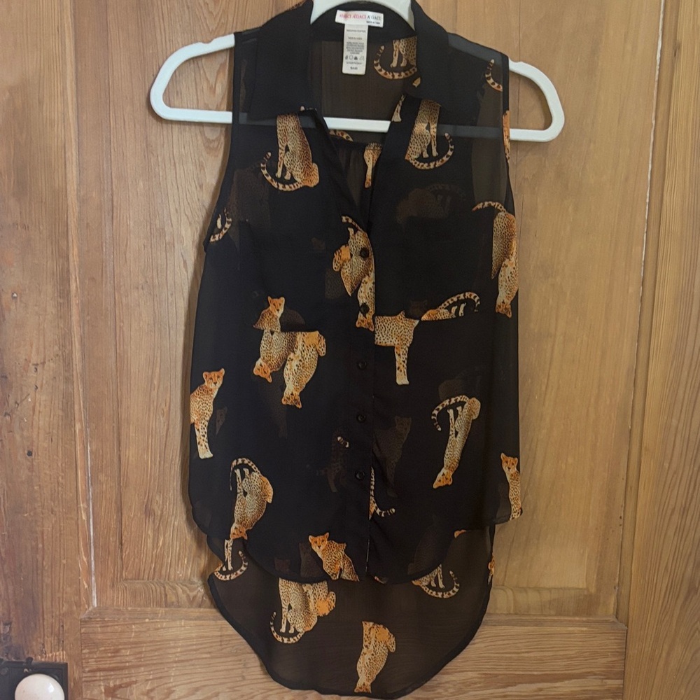 Black sheer collared sleeveless blouse w/asymmetrical hem and cheetah print